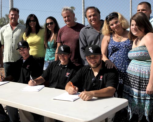 From left to right, Austin Evans, Mike Blanke and Mike Schwartz sign their professional contracts with the Chicago White Sox.